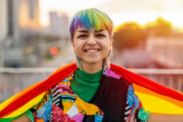 Portrait of a gender fluid person wearing rainbow flag