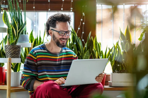 Young Man Working Home Laptop Surrounded Houseplants — Stock Photo, Image