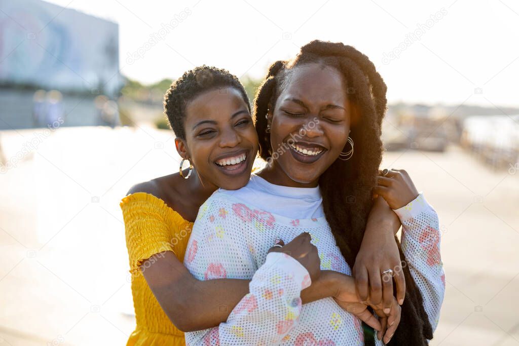 Happy young women enjoying the outdoors at sunset 
