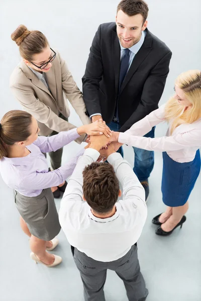 Young business people joining hands in circle Stock Picture