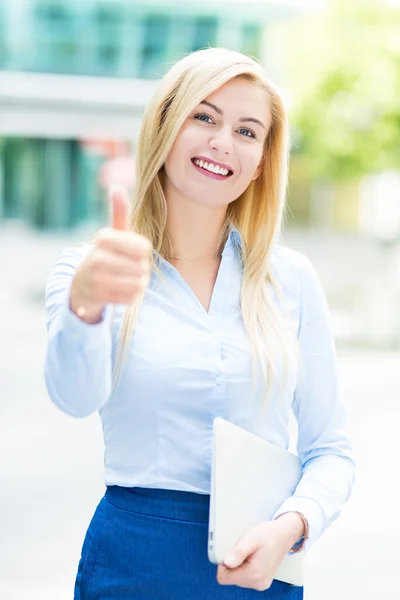 Young businesswoman holding laptop — Stock Photo, Image