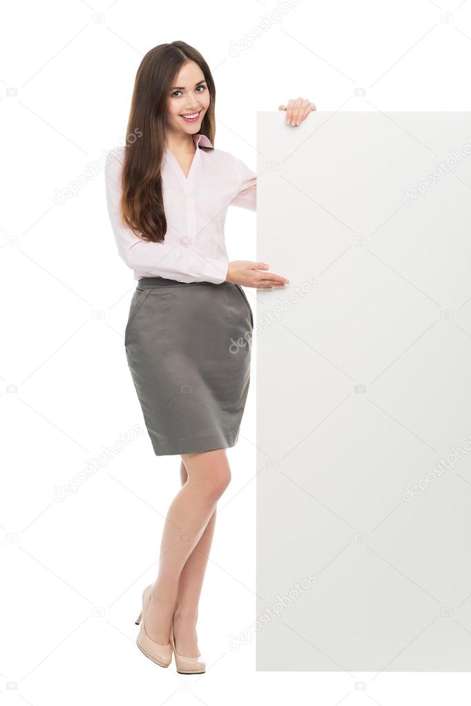 Woman standing next to big white poster