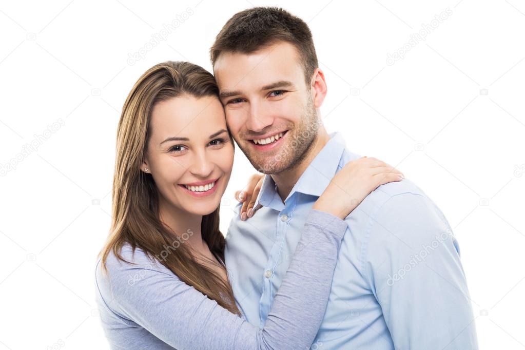 Young couple smiling and hugging