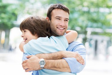 father and little son hugging