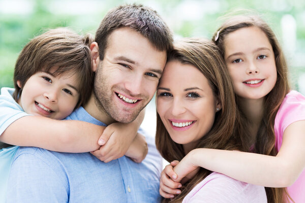 Happy young family hugging