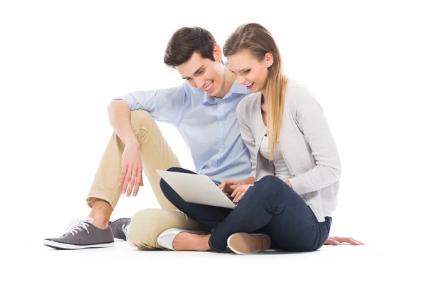 Young couple using laptop — Stock Photo, Image