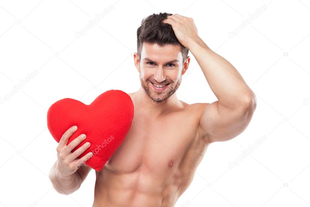 Muscular man holding heart shape