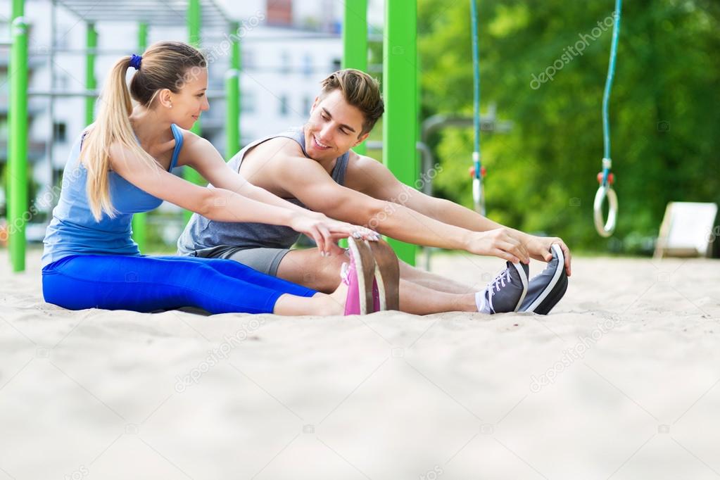 Young couple training outdoors