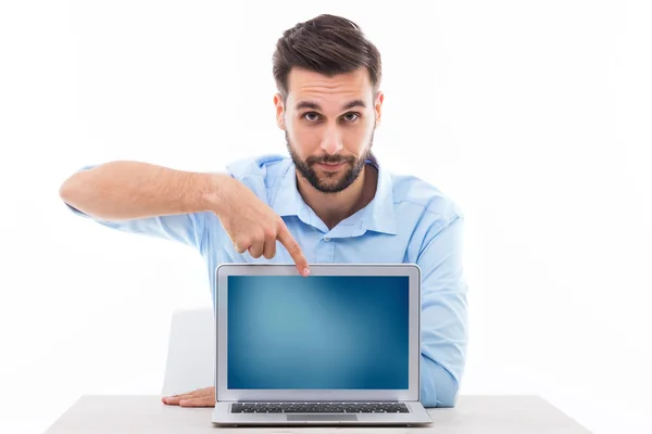 Young man at desk with laptop — Stock Photo, Image
