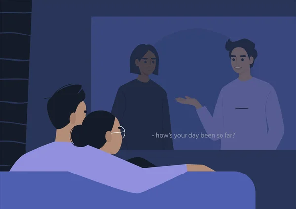 Genç bir çift bir video projektöründe sarılıp film seyrediyor.