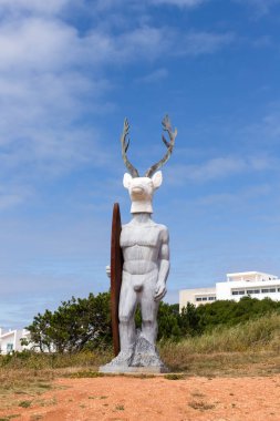 Nazare, Portugal - June 27, 2021: The famous statue of the deer surfer the surfista da Nazare.