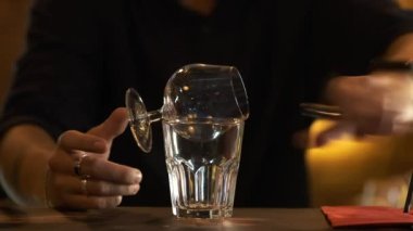 Barmen Sambuca 'yı bir bardakta yakar ve başka bir bardağa doldurur. Barda kokteyl hazırlıyorum..
