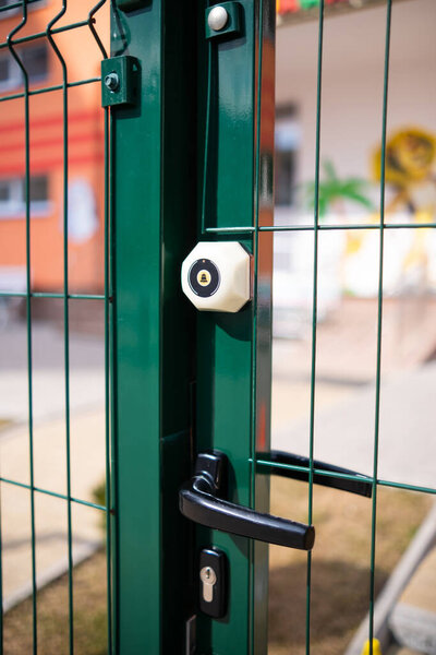 black handle in green door. modern metal fence
