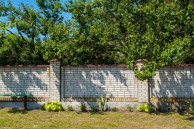 Sütunlu beyaz tuğlalardan dekoratif modern çitler..