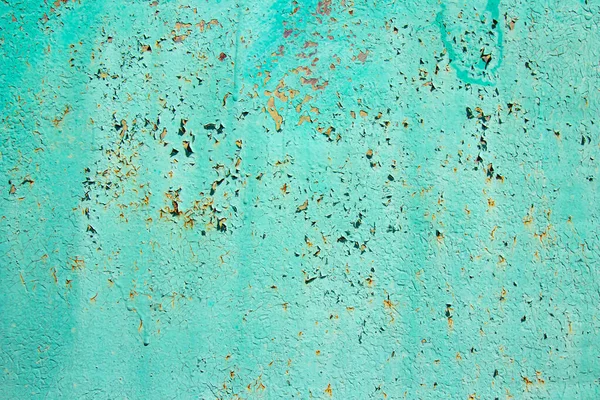 Pattern of old painted metal surface. Rusty metal, peeling paint, green tones, bright colors