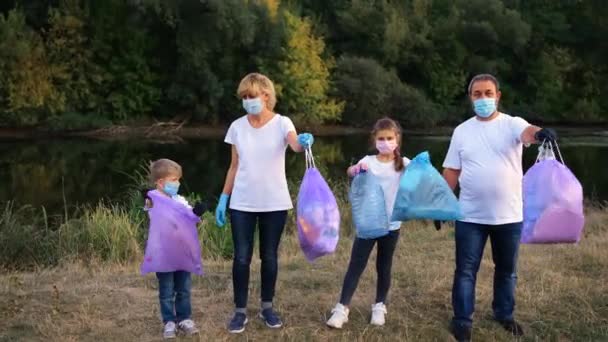 Une Famille Bénévoles Posant Avec Des Sacs Plastique Bleu Montrant — Video