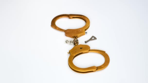 Golden Handcuffs Rotate White Background Concept Corruption Economic Crime — Stock Video