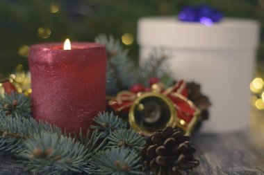Christmas background with bells and cones on christmas tree branch