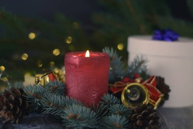 Christmas background with bells and cones on christmas tree branch