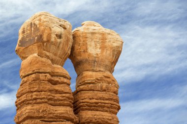 top of twin rock columns in a cloudy sky clipart