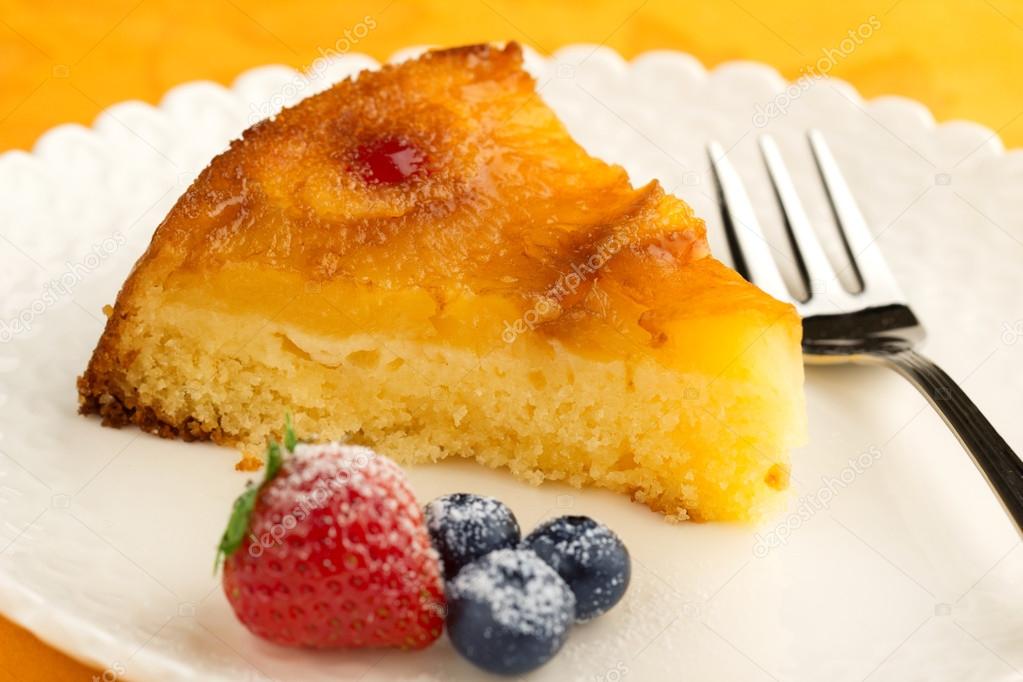 Slice of pineapple cake garnished with berries