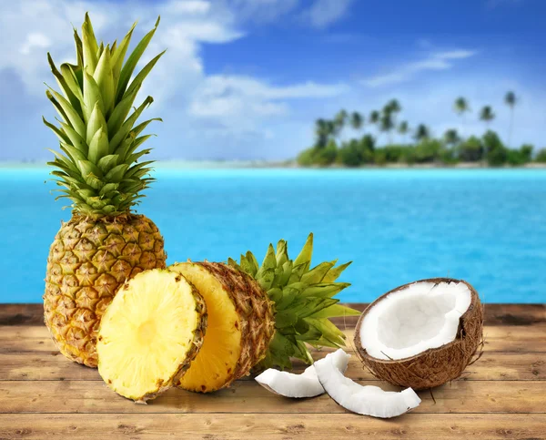 Fresh pineapple and coconut in tropical landscape — Stock Photo, Image
