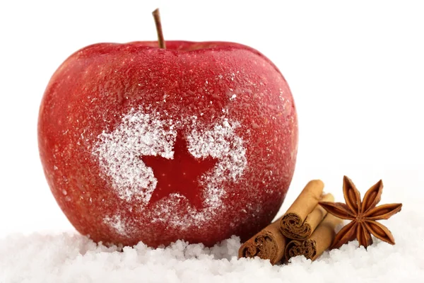 Dekorierter roter Apfel und Gewürze im Schnee — Stockfoto