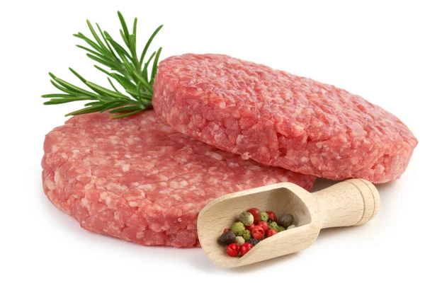 Raw burgers, rosemary and scoop with pepper — Stock Photo, Image