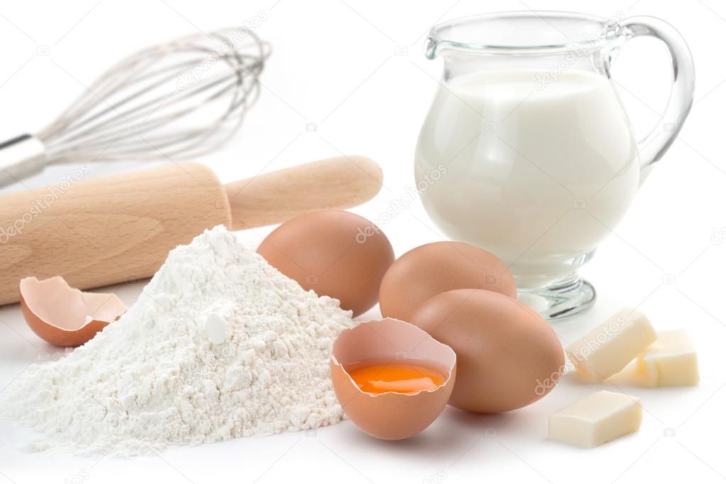 Eggs, flour, milk, butter and kitchen utensils