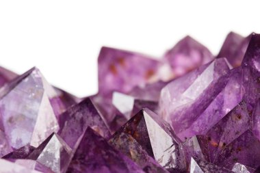 Close up of amethyst crystals on white background clipart