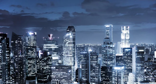 Panoramic view of illuminated skyscrapers at night — Stock Photo, Image