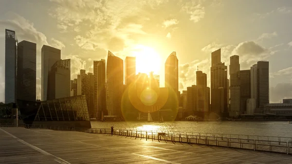 Skyscrapers in backlight with flare at sunset — Stock Photo, Image