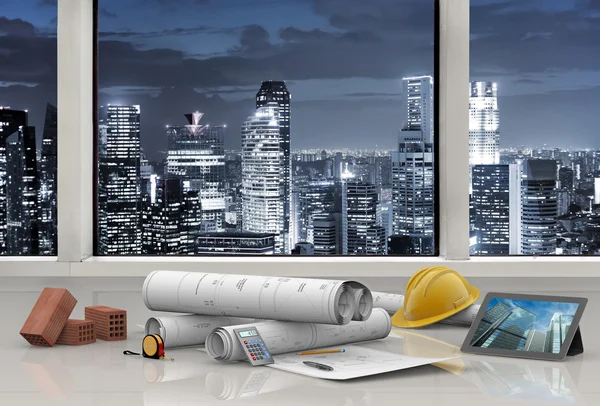 Work tools in architect's office with city skyline — Stock Photo, Image