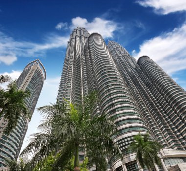 High-rises under a blue sky bottom view