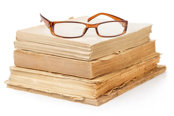 Gafas graduadas en una pila de libros antiguos — Foto de Stock