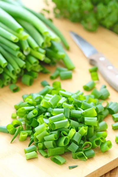 Spring onion on the wooden table — Stock Photo, Image