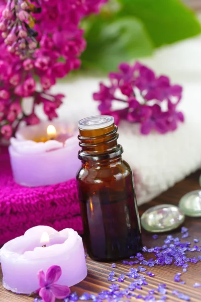 SPA setting with candles, aroma oil and lilac — Stock Photo, Image