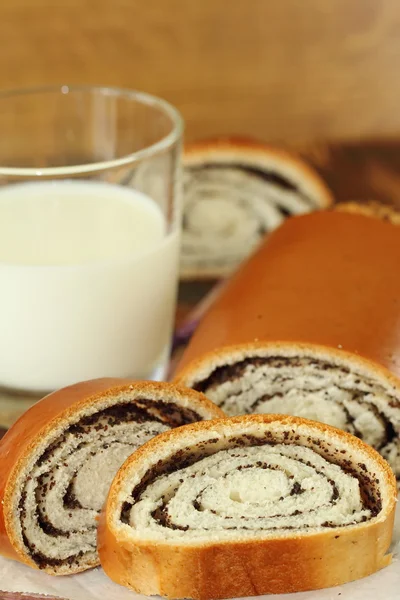 Roll with poppy seeds and milk — Stock Photo, Image