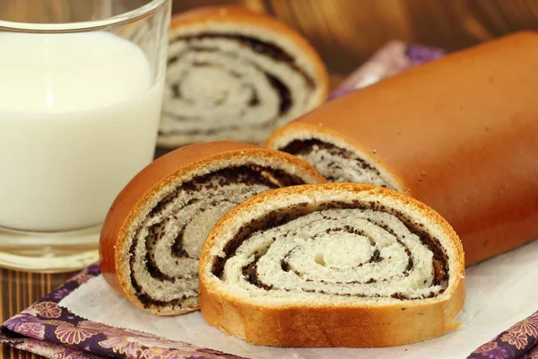 Roll with poppy seeds and milk — Stock Photo, Image