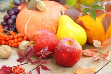 Autumn still life with assorted fruit, vegetables, berries and nuts