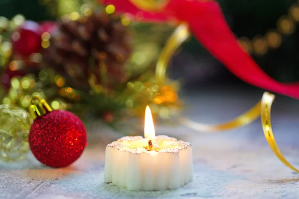 Burning candle with christmas decoration Royalty Free Stock Photos