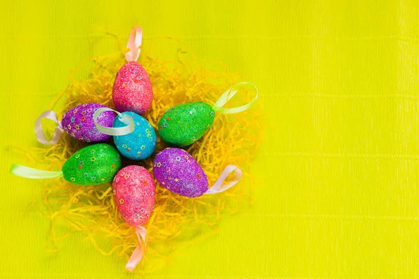 Renkli, elle boyanmış, parlak, sarı bahar arkaplanlı pastel Paskalya yumurtaları. Yüksek kalite fotoğraf