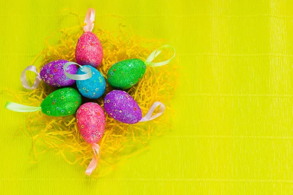 Renkli, elle boyanmış, parlak, sarı bahar arkaplanlı pastel Paskalya yumurtaları. Yüksek kalite fotoğraf