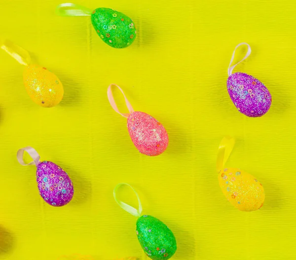 Renkli, elle boyanmış, parlak, sarı bahar arkaplanlı pastel Paskalya yumurtaları. Yüksek kalite fotoğraf
