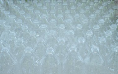 Üst üste birkaç boş, kapaksız plastik şişe istiflenmişti..