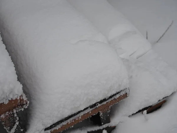 wooden steps of the porch are covered with frost.