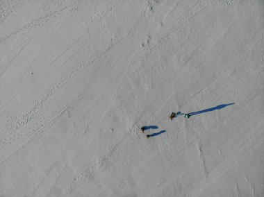Donmuş bir kış nehrinde yürüyen insanların en üst görüntüsü..