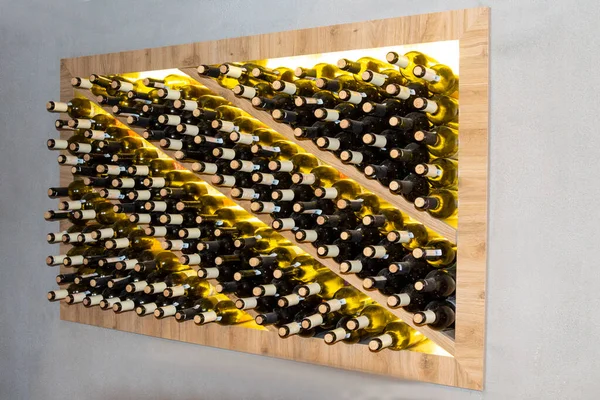 wine bottles in a wooden rack in the wine cellar. Storage of wine in wooden niches