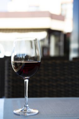 a glass of red wine in a glass at the bar on the table