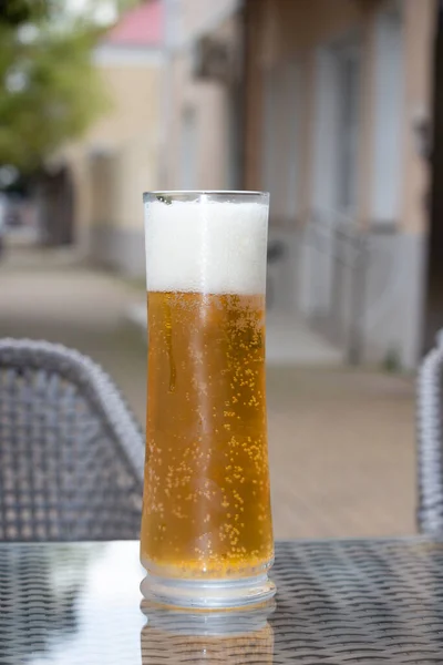 Beer with a glass mug on the table on the terrace of an outdoor cafe. Summer holidays — Stock Photo, Image